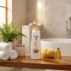Woman enjoying soft silky hair after using Dove Nourishing Oil Care Shampoo 170ml
