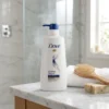 Woman using Dove Intense Repair Shampoo 650ml for smooth silky hair